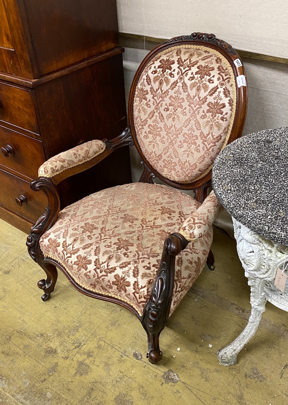 A Victorian carved walnut spoon back open armchair, width 71cm, depth 60cm, height 95cm